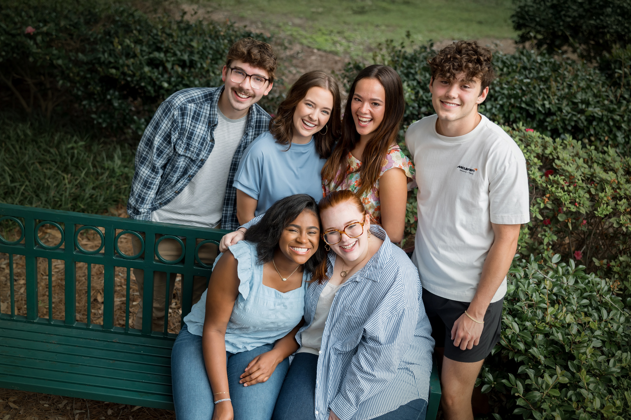 Students gathered around a bench on the quad.
