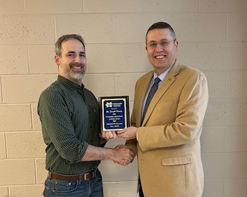 Dr. Joseph Kazery, left, MC instructor in biological sciences, receives Mississippi College's inaugural Outstanding Undergraduate Academic Advisor Award from MC Provost and Executive Vice President Mike Highfield.