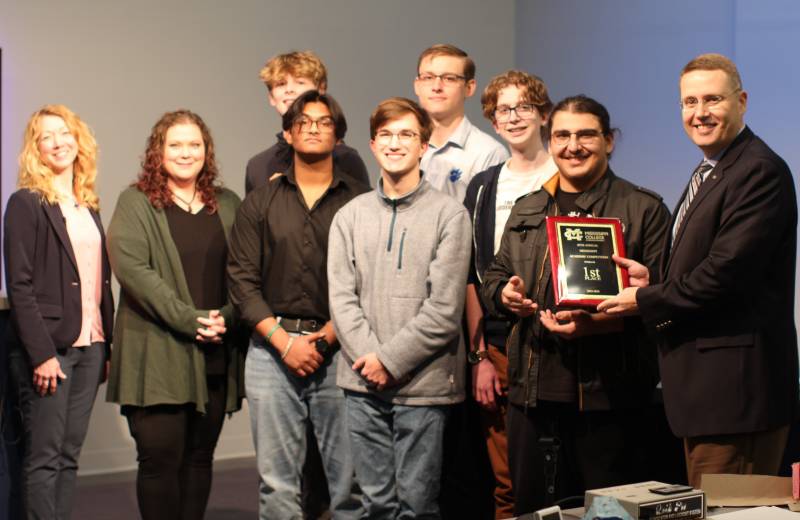 Dr. Michael Highfield, right, MC provost and executive vice president and former Mississippi College Academic Competition participant, presents the championship plaque to the Madison Central High School team while Cheli Vance, left, program coordinator in the Office of Continuing Education and tournament emcee, watches.