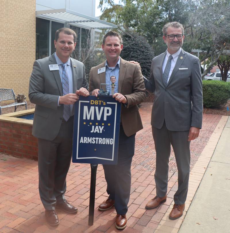 Mississippi College President Blake Thompson, left, presents his DBT's MVP Award for November to Jay Armstrong, center, while MC Law Dean John Anderson observes. 