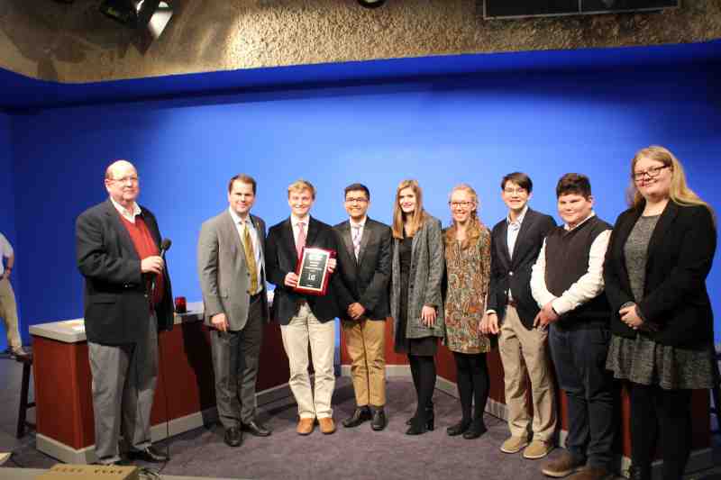 Moderator Tommy Leavelle joins President Blake Thompson to congratulate Parklane Academy students winning the 36th annual Mississippi Academic Competition at Mississippi College. Leavelle serves as an MC mathematics professor.