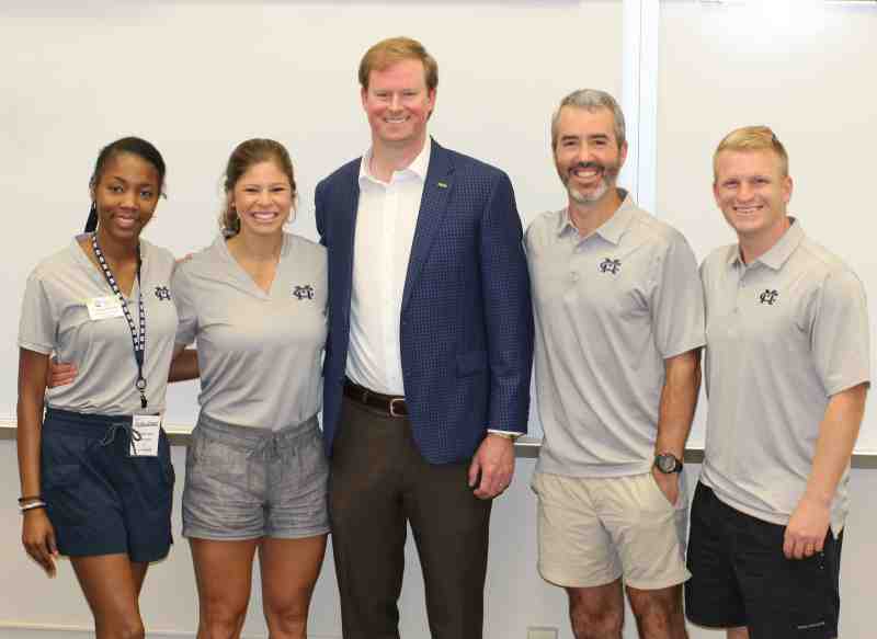 Lee McCarty, center, president of the Forest/Raleigh Division of Community Bank, visits with Mississippi College enrollment professionals after his NABEP 2023 Summer Conference presentation.