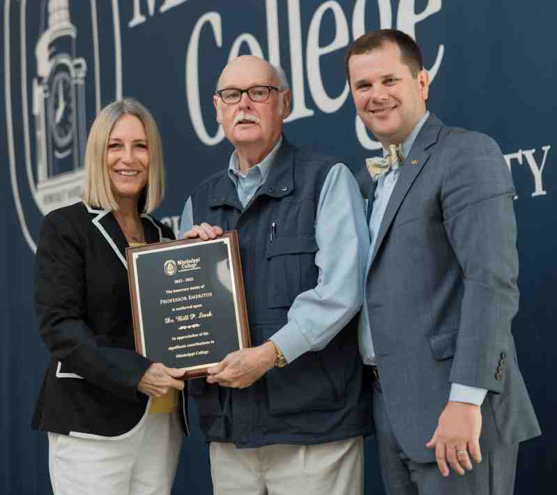 Blake Thompson, right, Mississippi College president, and Debbie Norris, MC associate provost and Graduate School dean, present a plaque signifying emeritus status to Bill Stark, center, W.O. Sadler Professor of Biology, during the Faculty and Staff Convocation Luncheon Aug. 19 in Anderson Hall. Stark joined three other emeritus recipients - Tommy Leavelle, J. Larry Lee, and Charlotte McMath - who were recognized for their distinguished record of scholarship, teaching, research, and service.to the University.