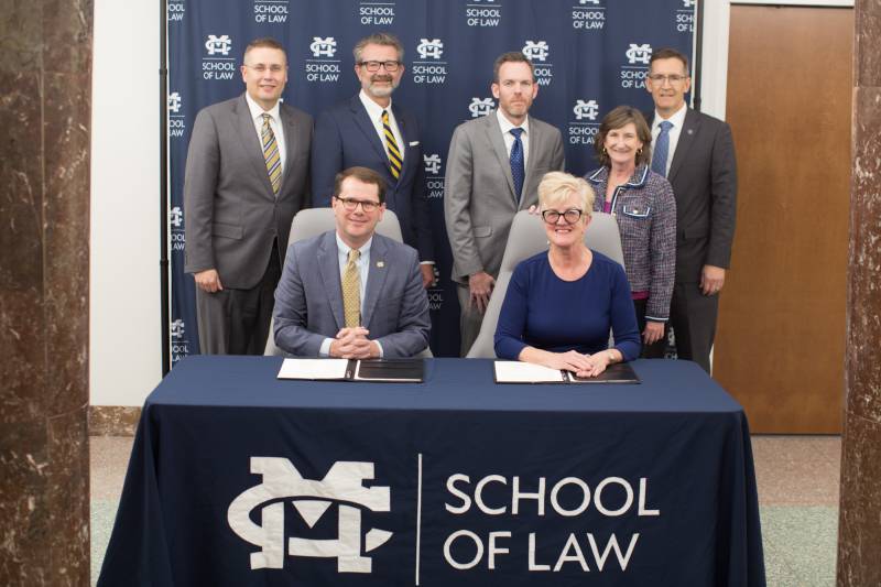 Seated from left, MC President Blake Thompson and The W President Nora Roberts Miller, and back row from left, MC Provost and Executive VP Mike Highfield, MC Law Dean John Anderson, The W Provost and Executive VP for Academic Affairs Scott Tollison, The W College of Business and Professional Studies Dean Kelly Woodford, and The W School of Arts and Science Dean Brian Anderson.