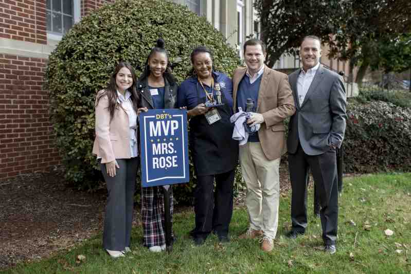 Joining Dr. Blake Thompson, second from right, MC president, in presenting the February DBT's MVP Award to Mrs. Rose, center, are, from left, Harley Bush, previous DBT's MVP winner, Camryn Johnson, senior student worker in Thompson's office, and Mike Prince, catering service manager.