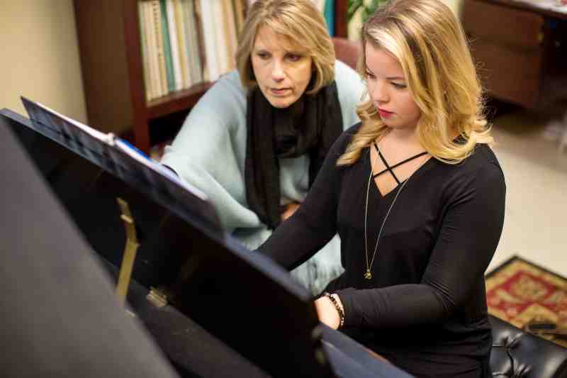 MC Music Department chair Angie Willoughby joins Sallie Kaye Streeter of Madison for a little work on a piano selection. Streeter is a recent MC graduate.