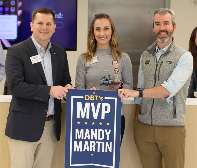 Michael Wright, right, dean of enrollment management, praises the welcoming environment Mandy Martin creates in Alumni Hall, which led Mississippi College President Blake Thompson to present her the DBT's MVP Award for January.