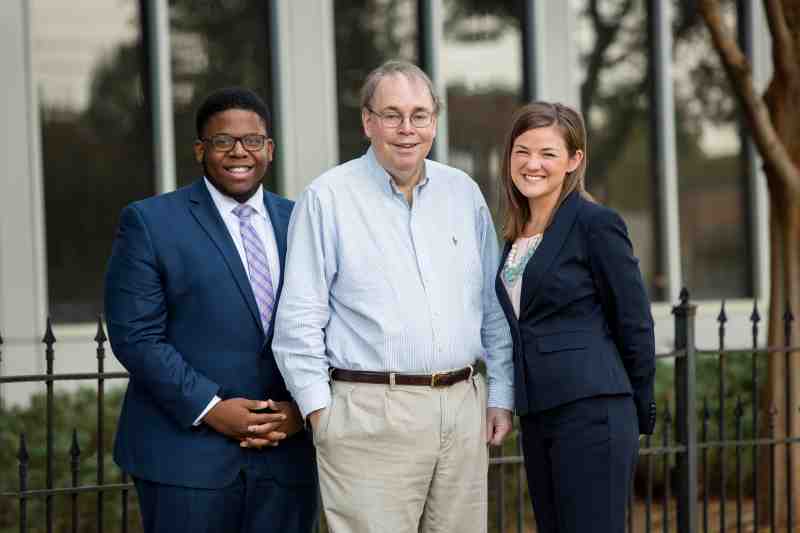 MC Law professor Lee Hetherington is pictured with students.