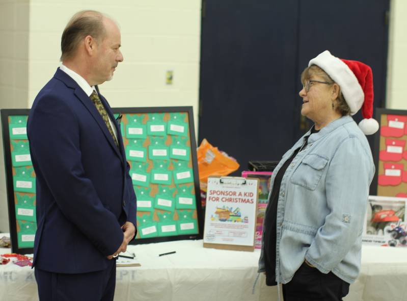 Shari Barnes discusses MC's 'Sponsor a Child' program with Ken Gilliam, MC director of continuing education. 