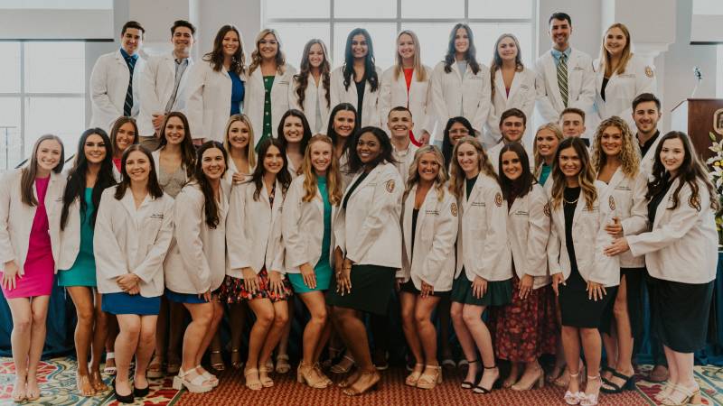 Members of the Mississippi College Physician Assistant Studies Program Class of 2025 show off their new coats following the White Coat Ceremony Aug. 31 in Anderson Hall.