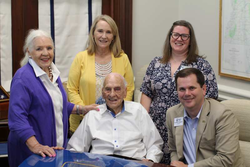 John N. DeFoore Sr., center, a member of the MC Class of 1947, enjoys a lighthearted moment during his visit with MC President Blake Thompson, right.