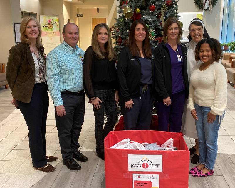 CeCe Sonia, right, presents donations from the Mississippi College chapter of MedLife to St. Dominic employees, from left, Kay McRee, St. Dominic Foundation executive director; Robby Channell, development officer; Mechale Mayfield, oncology service line director; Jennifer Davis, clinical supervisor-radiation therapy; Beth Little, oncology services social worker; and Sister Dorothea, St. Dominic Foundation associate executive director.