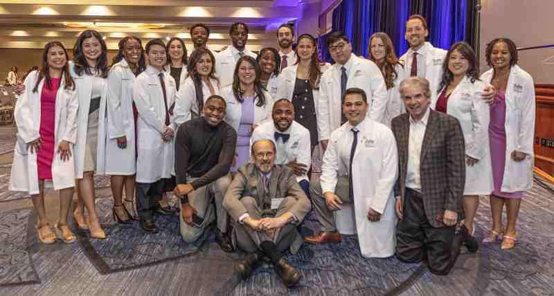 Stan Baldwin, second row, far right, visits with Mississippi College graduates who received their white coats as members of the Tufts University School of Dental Medicine's Class of 2025.