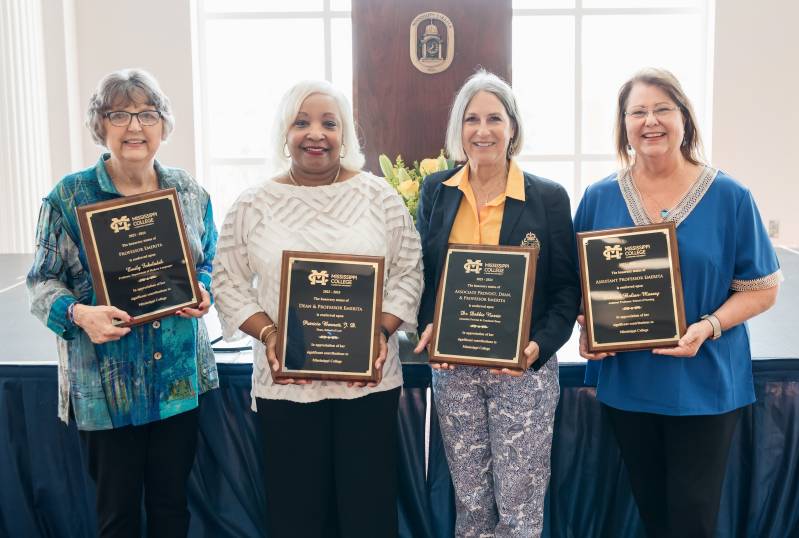 Mississippi College's newest recipients of emeritus status, from left, Emily Fokeladeh, Patricia Bennett, Debbie Norris, and Deborah Bolian Massey, display plaques that recognize their significant achievement.